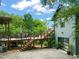 Exterior of the home featuring a patio area with an outdoor dining set surrounded by lush landscaping at 701 Holloway St, Durham, NC 27701