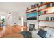 Inviting living room features a fireplace, built-in shelves and hardwood floors, creating a cozy atmosphere at 701 Holloway St, Durham, NC 27701