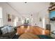Spacious living room featuring hardwood floors, white walls, and modern furnishings, complemented by a blue rug at 701 Holloway St, Durham, NC 27701