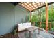 Inviting outdoor patio with comfortable seating and a decorative rug, set under a charming pergola amidst lush greenery at 701 Holloway St, Durham, NC 27701