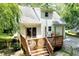 Rear exterior showcasing a spacious deck, stairs, and access to the backyard at 711 W Carver St, Durham, NC 27704