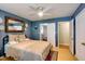 Serene bedroom featuring a cozy bed, a large mirror, and an en-suite bathroom for convenience at 711 W Carver St, Durham, NC 27704