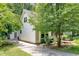 View of the side of a house, driveway, and backyard at 711 W Carver St, Durham, NC 27704