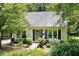 Charming home featuring a well-manicured front yard, a light exterior, and a welcoming entrance at 711 W Carver St, Durham, NC 27704