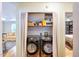 Convenient laundry closet with washer and dryer hookups and a view to the living room at 711 W Carver St, Durham, NC 27704