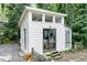 Exterior view of the outbuilding with plentiful windows and double door at 711 W Carver St, Durham, NC 27704