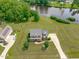 Beautiful aerial shot of a two-story home with lush lawn and a tranquil pond backdrop at 7217 Leando Dr, Willow Springs, NC 27592