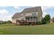 Backyard view showcasing a two-story home with a deck and screened-in porch at 7217 Leando Dr, Willow Springs, NC 27592