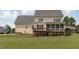A rear view of a two-story home featuring a deck and screened-in porch at 7217 Leando Dr, Willow Springs, NC 27592