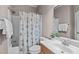 Cozy bathroom featuring a shower-tub combination, vanity with sink, floral shower curtain and towel rack at 7217 Leando Dr, Willow Springs, NC 27592