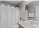 Bathroom displaying a toilet, shower with a white curtain, sink, and mirror at 7217 Leando Dr, Willow Springs, NC 27592