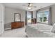 Bedroom boasting neutral paint, a queen bed, and two bright windows at 7217 Leando Dr, Willow Springs, NC 27592