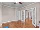 A versatile room featuring hardwood floors, white trim, and French doors to offer potential as an office space at 7217 Leando Dr, Willow Springs, NC 27592