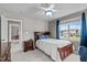 Bedroom with a wood bed frame, a ceiling fan, and ample natural light at 7217 Leando Dr, Willow Springs, NC 27592