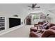 Bonus room with a ceiling fan, projector screen, and a large brown sectional couch at 7217 Leando Dr, Willow Springs, NC 27592