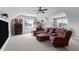 Bonus room showing a brown sectional couch, ceiling fan, and carpet at 7217 Leando Dr, Willow Springs, NC 27592