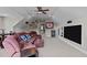 Bonus room featuring a projector screen, carpet, and a large brown sectional couch at 7217 Leando Dr, Willow Springs, NC 27592