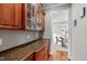 Butler's pantry with a countertop, storage cabinets, and a view into the dining room at 7217 Leando Dr, Willow Springs, NC 27592