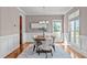 Dining area featuring a modern chandelier, wainscoting, and a window with natural light at 7217 Leando Dr, Willow Springs, NC 27592