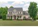 Stately two-story home with a welcoming front porch and meticulously landscaped lawn at 7217 Leando Dr, Willow Springs, NC 27592
