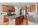 A stylish kitchen featuring granite countertops, stainless steel appliances, and a central island at 7217 Leando Dr, Willow Springs, NC 27592