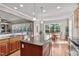 Spacious kitchen featuring a central island with granite countertops and an adjacent breakfast area with hardwood floors at 7217 Leando Dr, Willow Springs, NC 27592