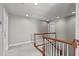 Upstairs landing with stairs, neutral carpet, and white walls, offering a transition between floors at 7217 Leando Dr, Willow Springs, NC 27592
