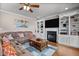 Inviting living room featuring hardwood floors, fireplace with built-in shelving, and a comfortable seating area at 7217 Leando Dr, Willow Springs, NC 27592