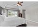 Spacious main bedroom with tray ceiling, carpet floors, dresser, and large windows with nature views at 7217 Leando Dr, Willow Springs, NC 27592