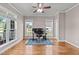 Bright office with multiple windows, hardwood floors, and a modern desk setup at 7217 Leando Dr, Willow Springs, NC 27592