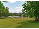 Scenic pond view showing calm waters and trees with lawn extending to the water's edge at 7217 Leando Dr, Willow Springs, NC 27592