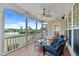 Enjoy beautiful water views from this screened-in porch with cozy wicker furniture at 7217 Leando Dr, Willow Springs, NC 27592
