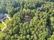 Secluded estate with home nestled among lush trees and private grounds from an aerial perspective at 7529 Tynewind Dr, Wake Forest, NC 27587