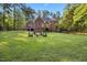 Expansive backyard with a fire pit area and lush green grass, perfect for outdoor living at 7529 Tynewind Dr, Wake Forest, NC 27587