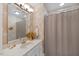 Bathroom with neutral walls and vanity with a single sink and decorative mirror at 7529 Tynewind Dr, Wake Forest, NC 27587