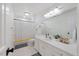 Bright bathroom featuring a shower with gray and yellow striped curtain, large mirror, and white vanity at 7529 Tynewind Dr, Wake Forest, NC 27587