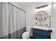 Stylish bathroom features a modern vanity with gold fixtures and round mirror at 7529 Tynewind Dr, Wake Forest, NC 27587
