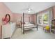 Bedroom features a four poster bed, ceiling fan, and neutral carpet at 7529 Tynewind Dr, Wake Forest, NC 27587