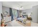 Neutral bedroom with blue accents, a ceiling fan, and a large window at 7529 Tynewind Dr, Wake Forest, NC 27587