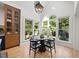 Bright breakfast nook features vaulted ceilings, large windows with a view, and stylish light fixture at 7529 Tynewind Dr, Wake Forest, NC 27587