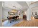 Open dining room with contemporary lighting, tray ceiling, and hardwood floors at 7529 Tynewind Dr, Wake Forest, NC 27587