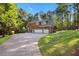 Charming brick home features a two-car garage and a beautifully landscaped yard with mature trees at 7529 Tynewind Dr, Wake Forest, NC 27587