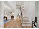 Bright foyer with hardwood floors, staircase, and access to multiple living spaces at 7529 Tynewind Dr, Wake Forest, NC 27587