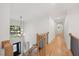 Bright foyer with a chandelier, large window, wood floors, and wood and metal railing at 7529 Tynewind Dr, Wake Forest, NC 27587