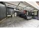 Bright and spacious garage featuring plenty of storage space, overhead racking, and a dark gray car at 7529 Tynewind Dr, Wake Forest, NC 27587