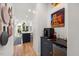 Hallway wet bar features a wine cooler, coffee machine, and view into the eat-in kitchen at 7529 Tynewind Dr, Wake Forest, NC 27587