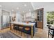 Spacious kitchen with large island, stainless steel refrigerator, and custom cabinetry at 7529 Tynewind Dr, Wake Forest, NC 27587