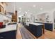 Bright, open kitchen with a large center island, farmhouse sink, and modern appliances at 7529 Tynewind Dr, Wake Forest, NC 27587