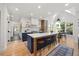 Modern kitchen with a large island, seating, custom cabinets, and high-end appliances at 7529 Tynewind Dr, Wake Forest, NC 27587