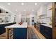 Open kitchen layout with expansive island, designer finishes, and stainless steel appliances at 7529 Tynewind Dr, Wake Forest, NC 27587